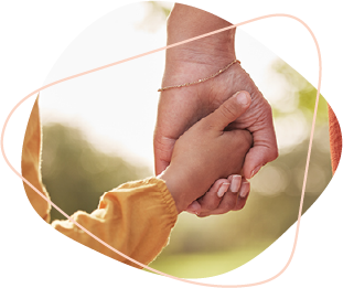 A child holding the hand of an adult