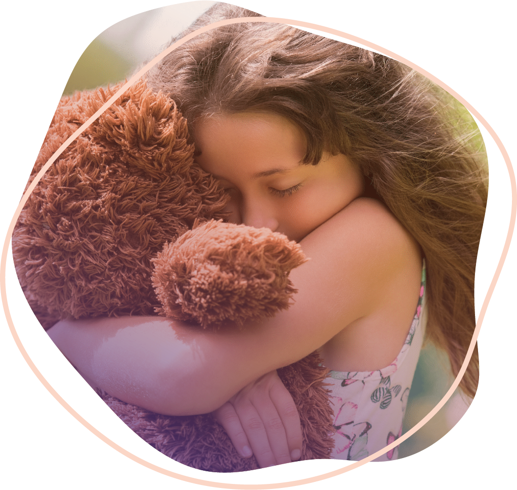 A child hugging a teddy bear