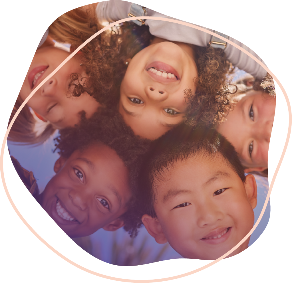 A group of children in a circle smiling