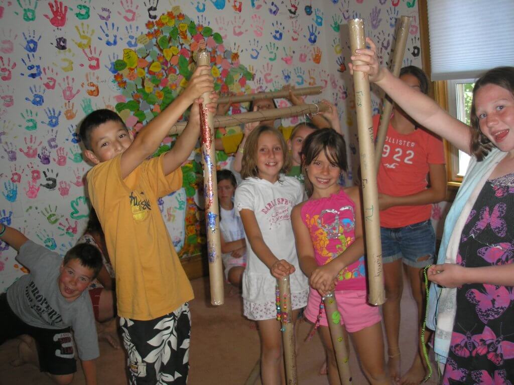 Children playing with rain sticks