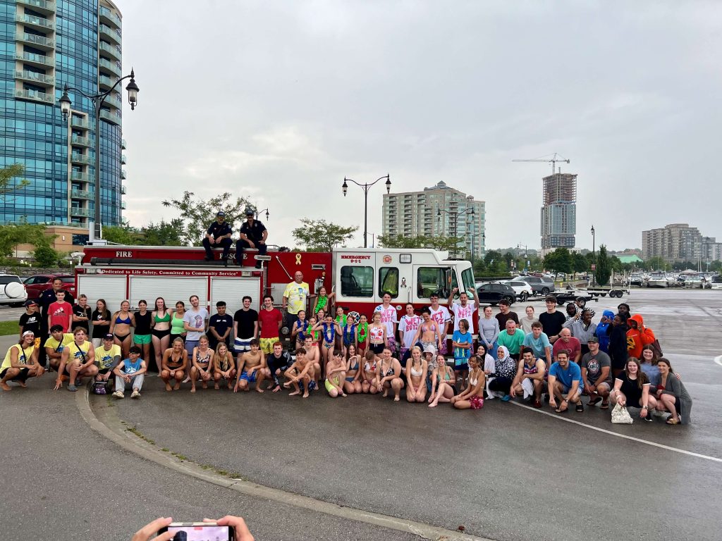 Seasons Centre group photo in front of a fire truck in downtown Barrie